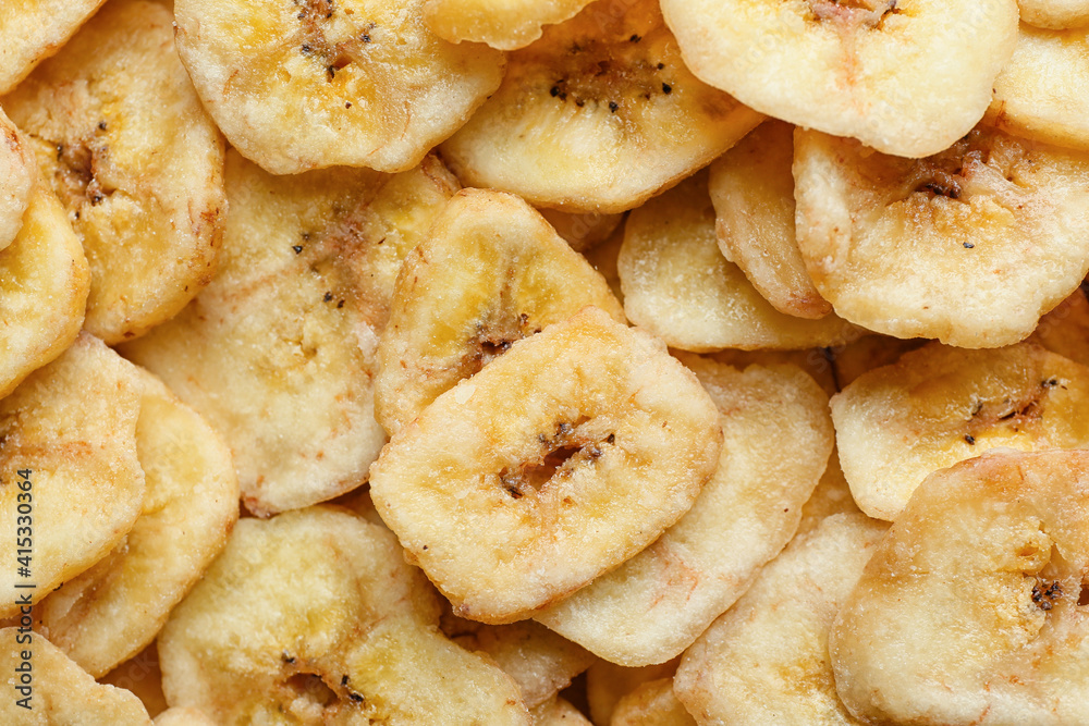 Tasty crispy banana chips as background