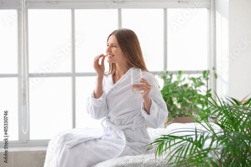 Beautiful young woman takin...