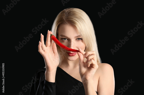 Sexy young woman with chili...