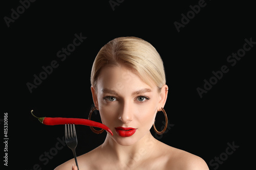 Sexy young woman with chili...