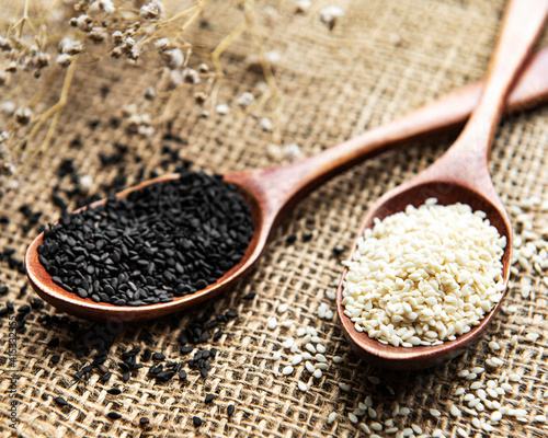 Black and white sesame seeds in a spoons