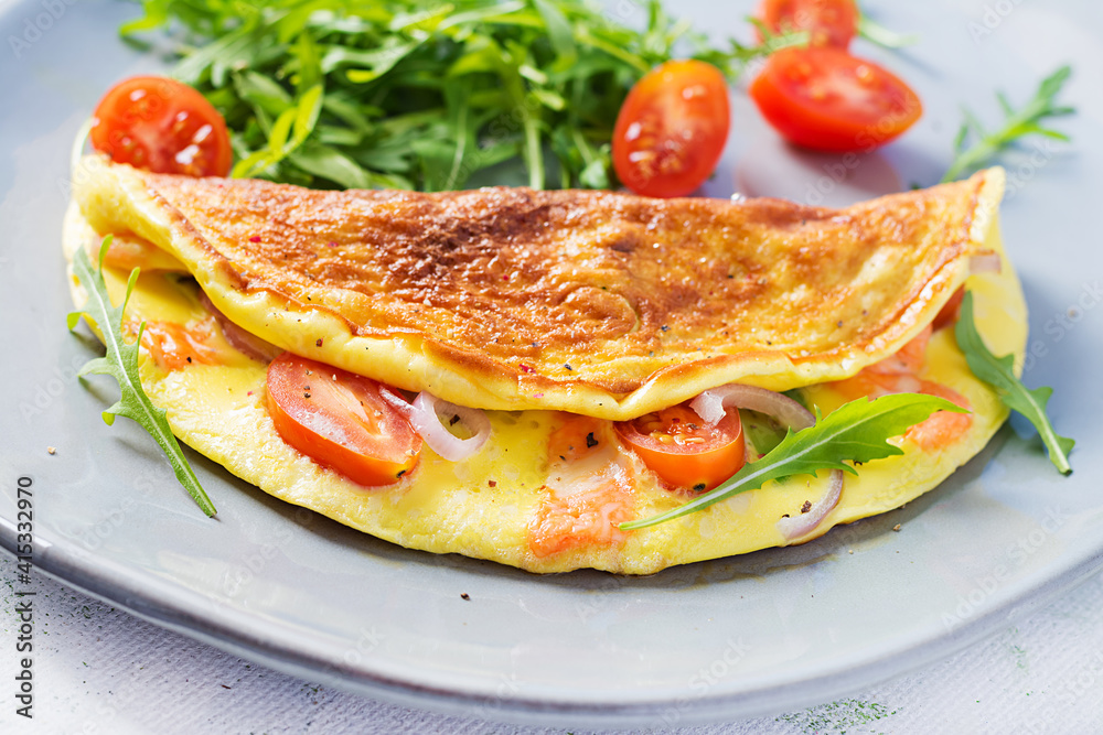 Keto breakfast. Omelette with cheese, tomatoes and avocado on light table. Italian frittata. Keto, ketogenic lunch. Keto breakfast. Omelette with cheese, tomatoes and avocado on light table. Italian frittata. Keto, ketogenic lunch.
