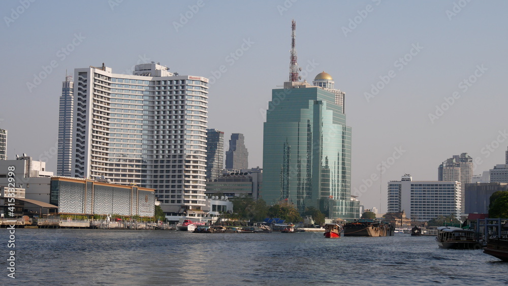 Cityscape of Bangkok with tourist boat on Chao Phraya River, Bangkok, Thailand
