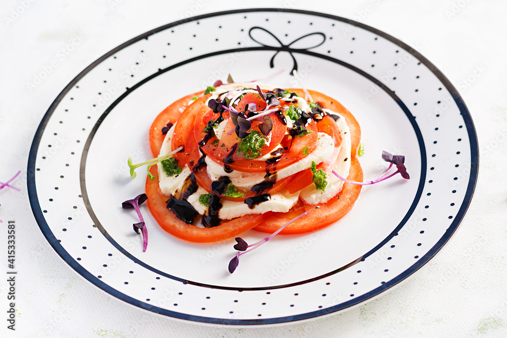Caprese salad. Mozzarella cheese, tomatoes and basil pesto on plate. Eco friendly concept. Caprese salad. Mozzarella cheese, tomatoes and basil pesto on plate. Eco friendly concept.