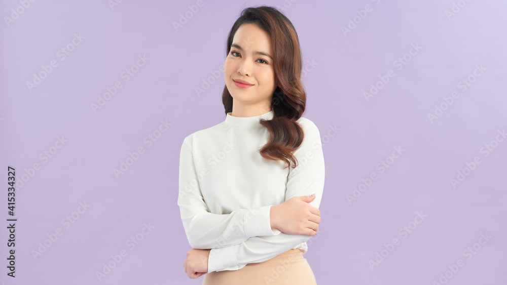 Happy business woman standing and smiling isolated on lilac background. Happy business woman standing and smiling isolated on lilac background.