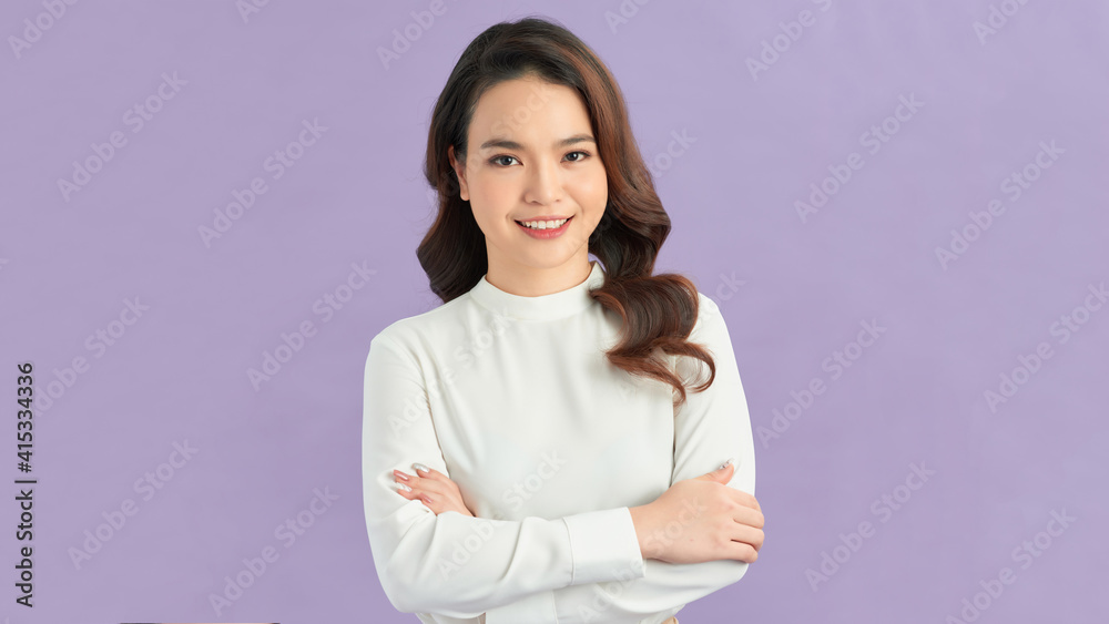 Photo of serious young lady with arms crossed dressed in white dress standing and posing over purple background. Photo of serious young lady with arms crossed dressed in white dress standing and posing over purple background.