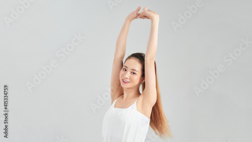 Young Asian woman stretching for exercise isolated on white background.