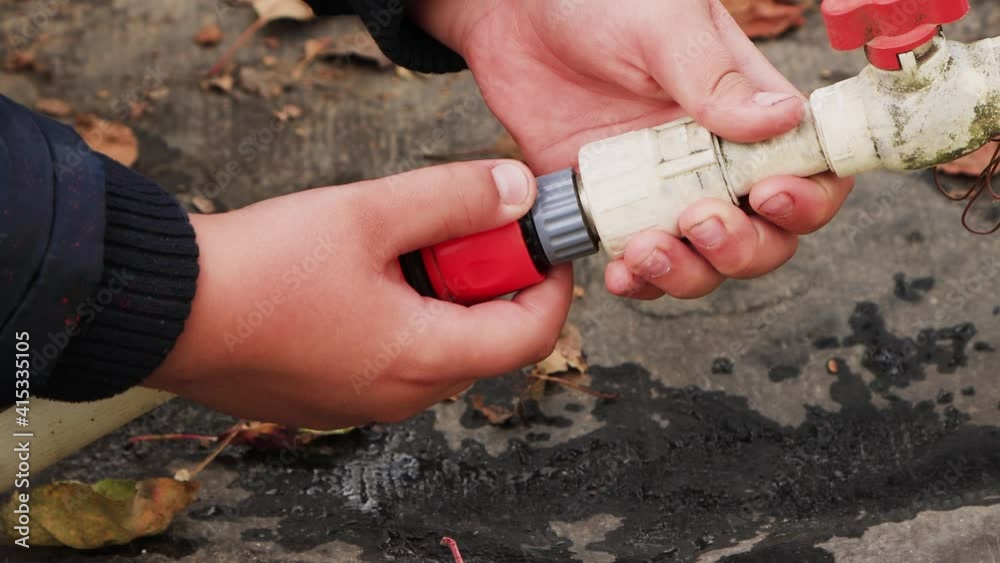Male hands detach plastic pipes with collet fasteners from each other