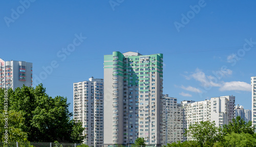 Modern residential apartment with flat buildings exterior. Detail of New luxury house and home complex. Part of City Real estate property and condo architecture. Blue sky