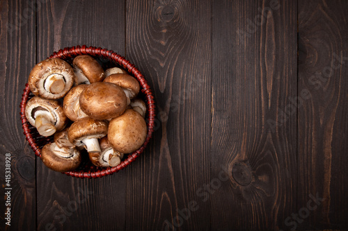 mushrooms in a basket on a dark wooden background top view with copy space