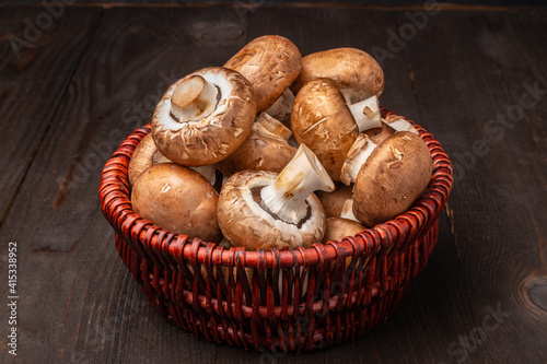mushrooms in a basket on a dark wooden background
