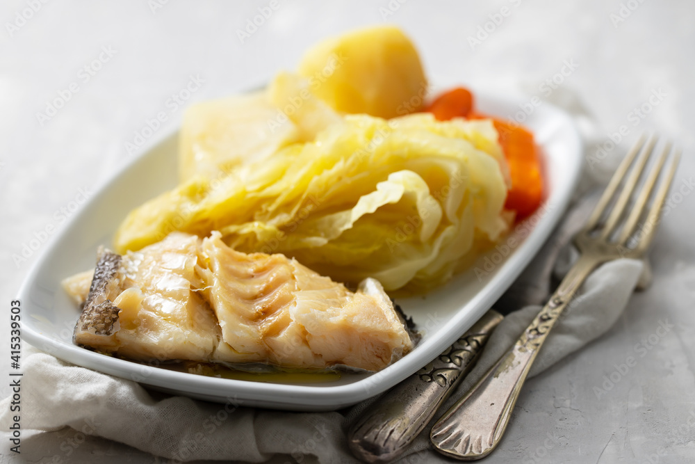 boiled cod fish with boiled vegetables and egg on white dish boiled cod fish with boiled vegetables and egg on white dish
