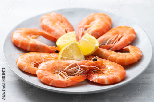 cooked shrimps with lemon on the dish