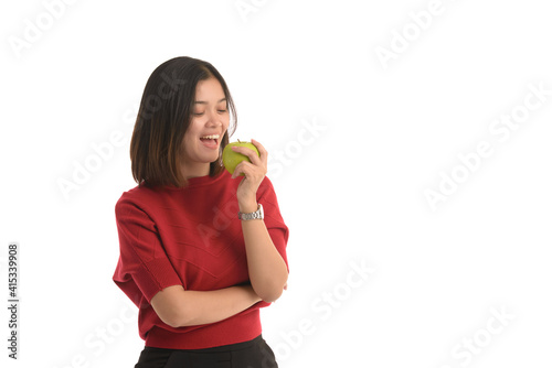 Asian woman is holding an apple with her left hand and look interesting on white background.