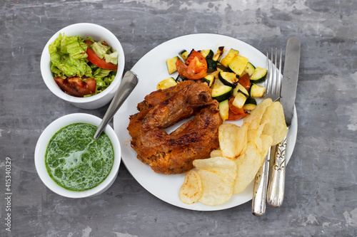 typical portuguese smoked sausage alheira with chips and greens photo