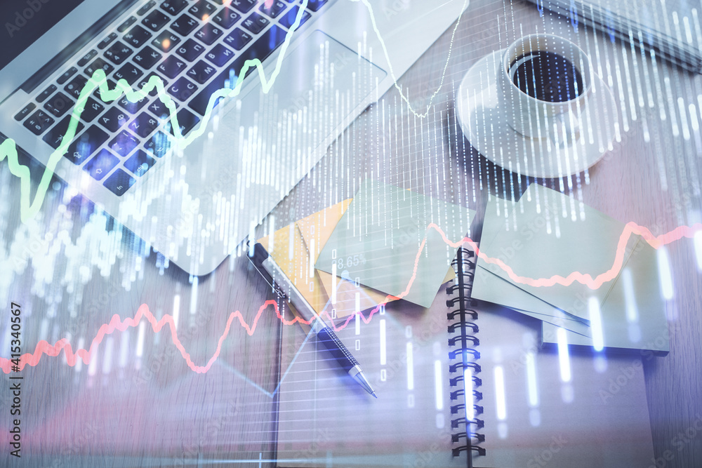 Stock market graph and top view computer on the table background. Double exposure. Concept of financial education. Stock market graph and top view computer on the table background. Double exposure. Concept of financial education.