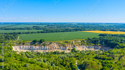 Aerial drone view - Beautiful summer landscape old chalk quarry. Bird view over nature landscape with old chalk quarry. Beautiful hilly. © Valua Vitaly