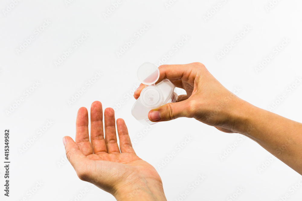 hands wiping with hydroalcoholic gel to avoid coronavirus infection on white background