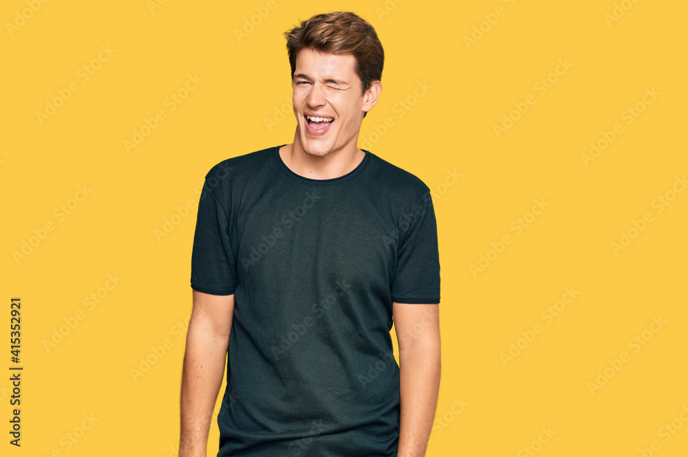 Handsome caucasian man wearing casual clothes winking looking at the camera with sexy expression, cheerful and happy face. Handsome caucasian man wearing casual clothes winking looking at the camera with sexy expression, cheerful and happy face.