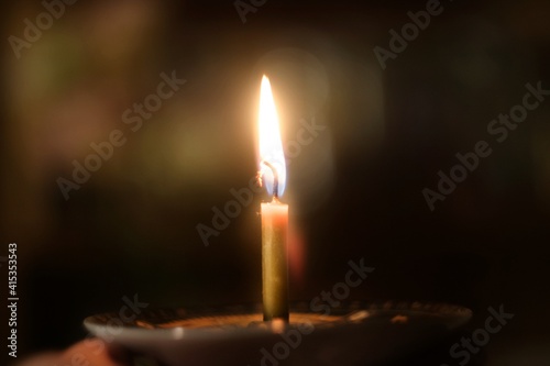 Burning candles on a church candlestick, a symbol of prayer
