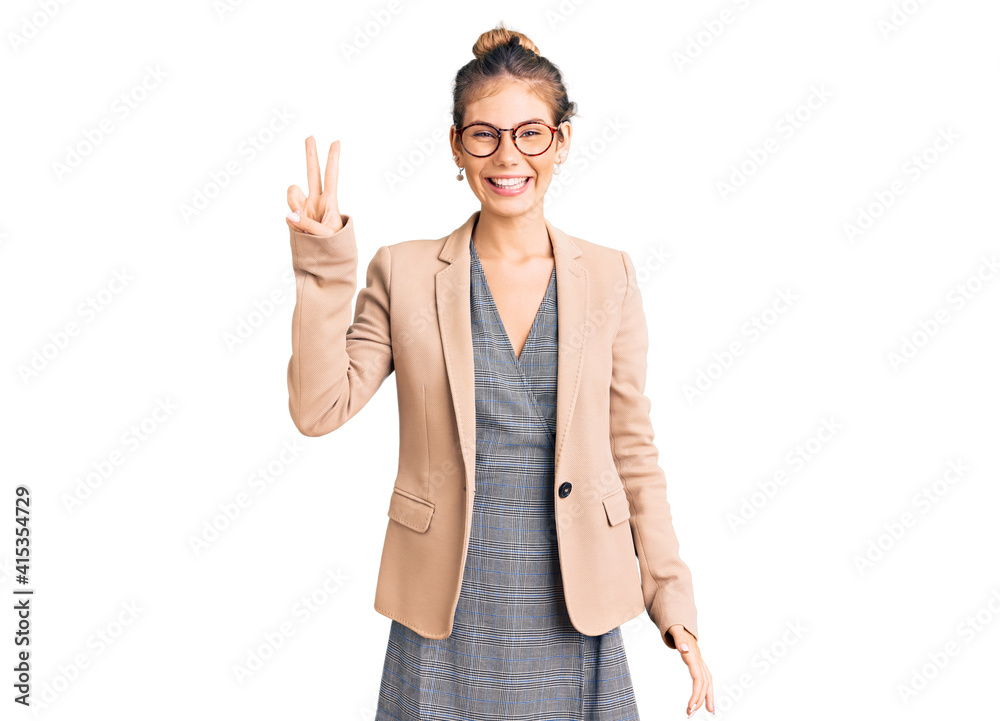 Beautiful caucasian woman with blonde hair wearing business jacket and glasses smiling with happy face winking at the camera doing victory sign. number two. Beautiful caucasian woman with blonde hair wearing business jacket and glasses smiling with happy face winking at the camera doing victory sign. number two.
