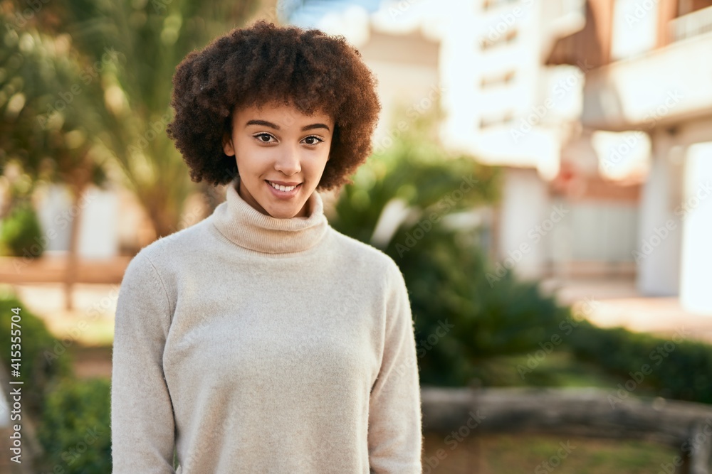 Fototapeta premium Young hispanic girl smiling happy standing at the city.
