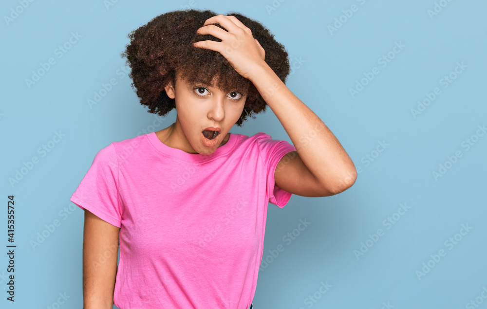 Young hispanic girl wearing casual clothes surprised with hand on head for mistake, remember error. forgot, bad memory concept. Young hispanic girl wearing casual clothes surprised with hand on head for mistake, remember error. forgot, bad memory concept.