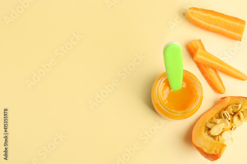 Flat lay composition with healthy baby food and ingredients on beige background. Space for text