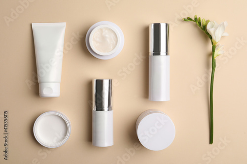 Set of luxury cosmetic products on beige background, flat lay