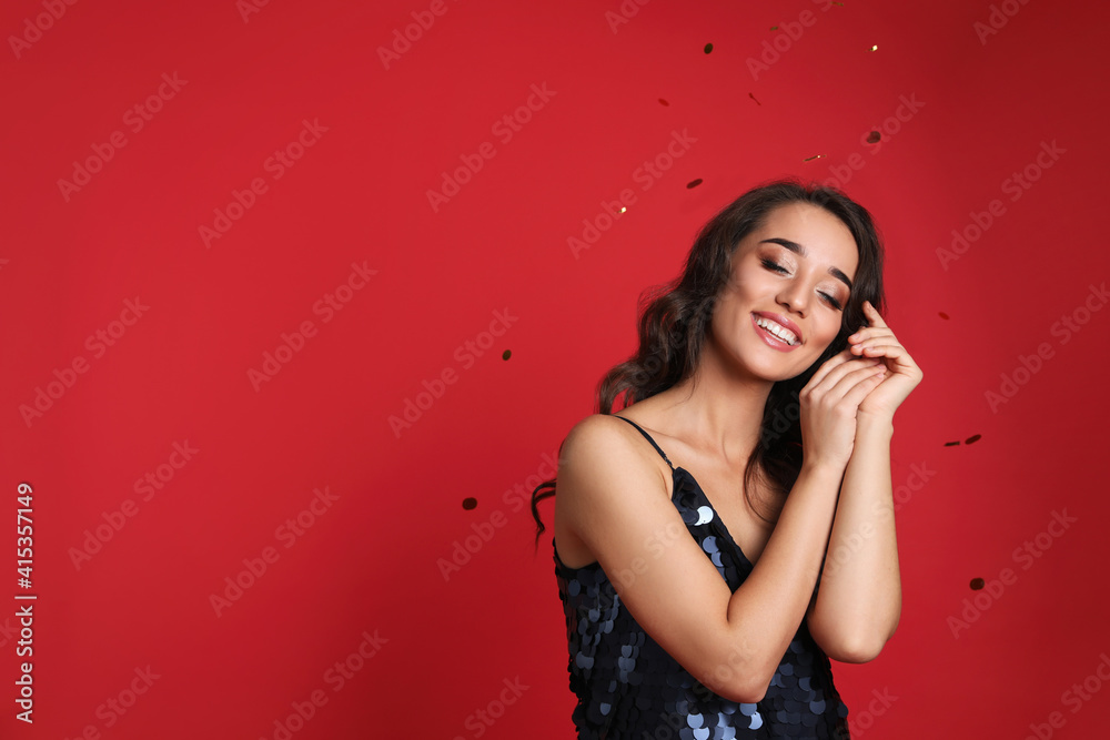 Beautiful young woman wearing elegant dress on red background, space for text. Christmas party