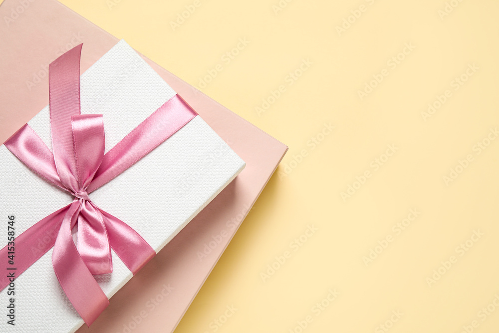 Beautiful gift boxes on beige background, top view. Space for text Beautiful gift boxes on beige background, top view. Space for text