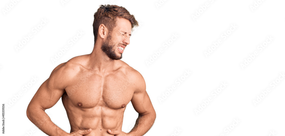 Young caucasian man standing shirtless with hand on stomach because nausea, painful disease feeling unwell. ache concept.