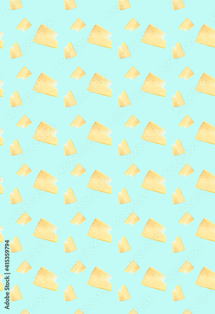 Vertical pattern with cut pieces of cheese on a blue background. Grocery background. Vertical pattern with cut pieces of cheese on a blue background. Grocery background.
