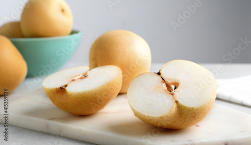 Cut and whole apple pears on table