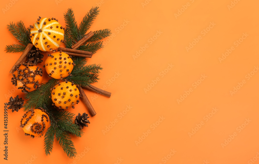 Flat lay composition with pomander balls made of fresh tangerines on orange background. Space for text