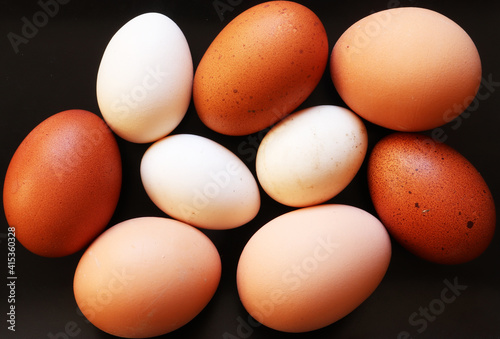 Photograph of eggs of three varieties of hen on slate background for food illustrations