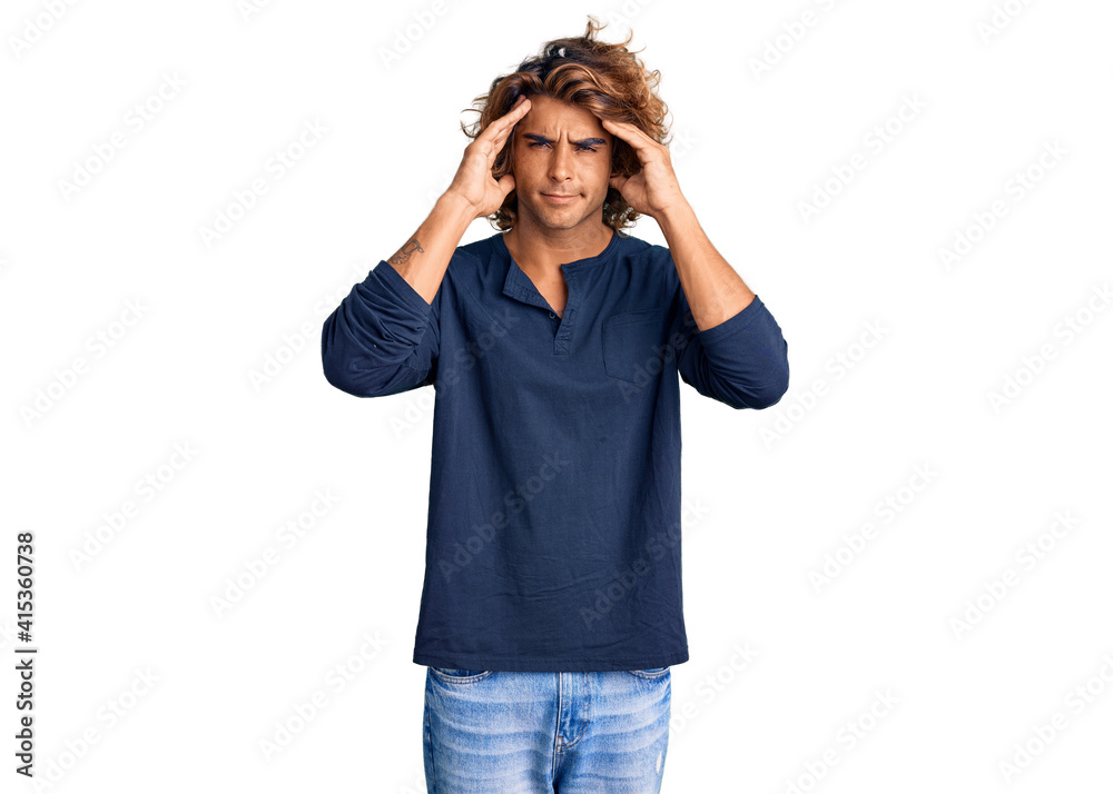 Young hispanic man wearing casual clothes with hand on head for pain in head because stress. suffering migraine. Young hispanic man wearing casual clothes with hand on head for pain in head because stress. suffering migraine.