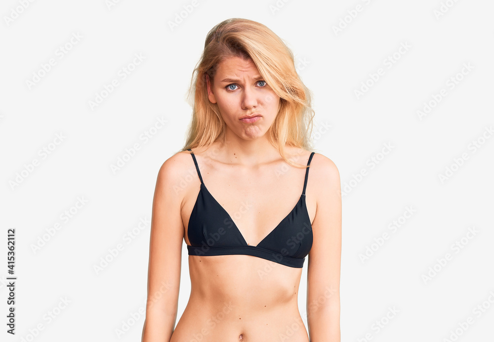 Young beautiful blonde woman wearing bikini depressed and worry for distress, crying angry and afraid. sad expression. Young beautiful blonde woman wearing bikini depressed and worry for distress, crying angry and afraid. sad expression.