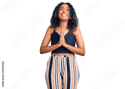 Young african american woman wearing casual clothes begging and praying with hands together with hope expression on face very emotional and worried. begging.