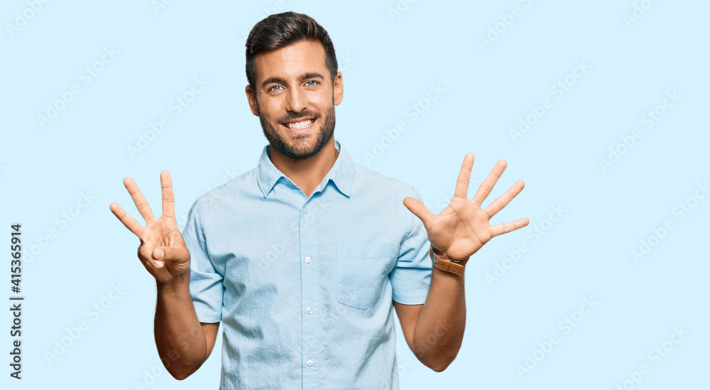 Handsome hispanic man wearing casual clothes showing and pointing up with fingers number eight while smiling confident and happy. Handsome hispanic man wearing casual clothes showing and pointing up with fingers number eight while smiling confident and happy.