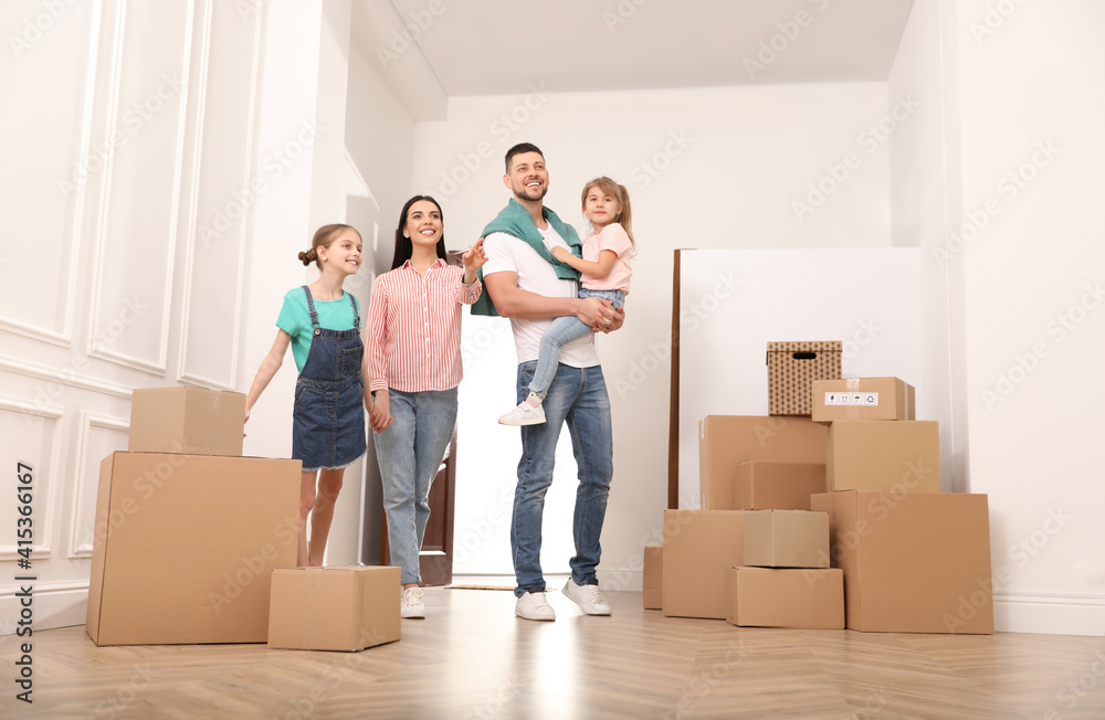 Happy family with children moving into new house Happy family with children moving into new house