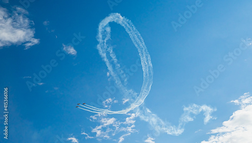 Stunt aircrafts performing incredible aerobatics. Aerial manoeuvre stunts. Planes does loop stunt with smoke trails