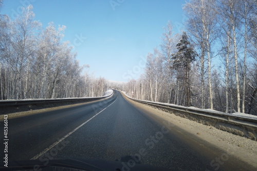 winter landscape with the road the forest © Yulia