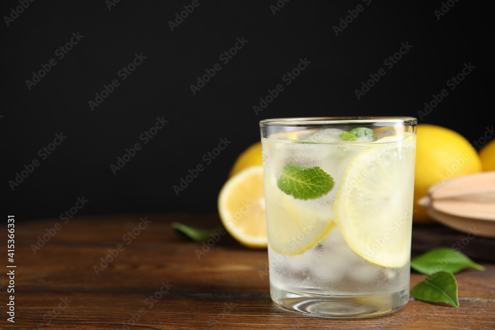 Cool freshly made lemonade in glass on wooden table. Space for text Cool freshly made lemonade in glass on wooden table. Space for text