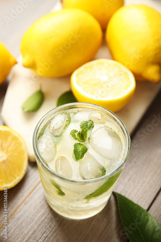 Cool freshly made lemonade and fruits on wooden table, above view