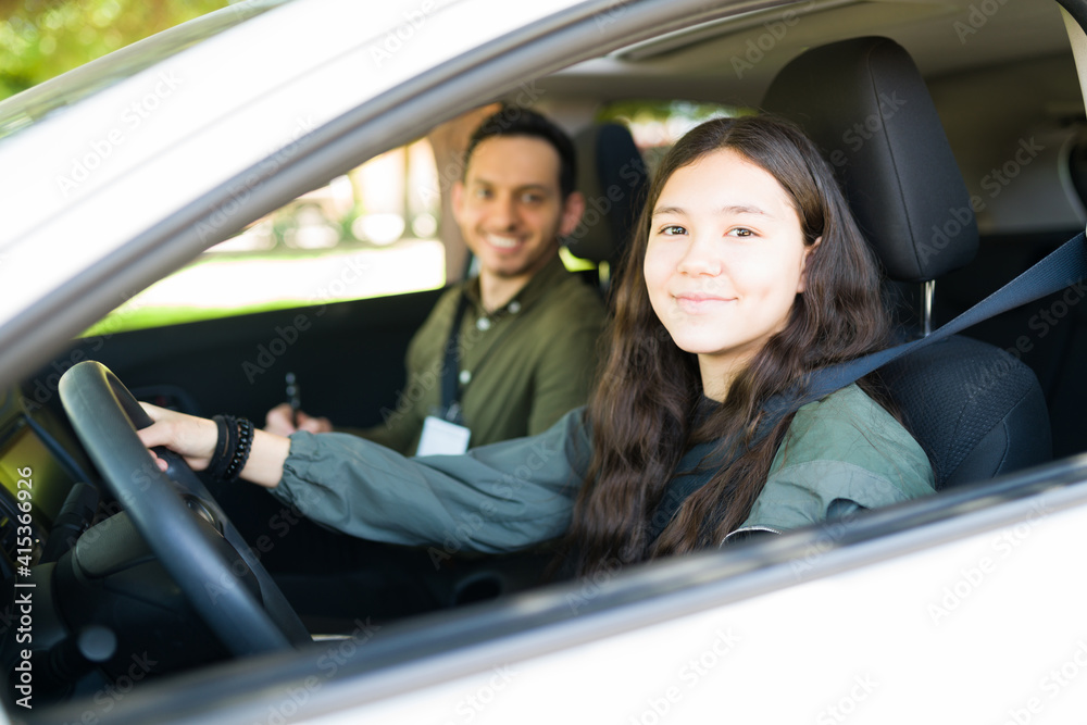 Portrait of a cute adolescent girl holding the steering wheel of the car Portrait of a cute adolescent girl holding the steering wheel of the car
