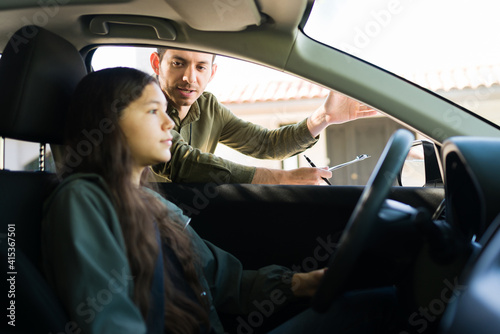 Caucasian teen girl ready to start her driving test © AntonioDiaz