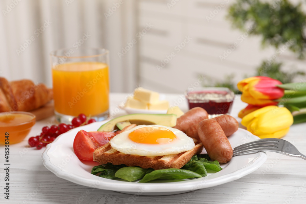 Delicious breakfast with fried egg served on white wooden table Delicious breakfast with fried egg served on white wooden table