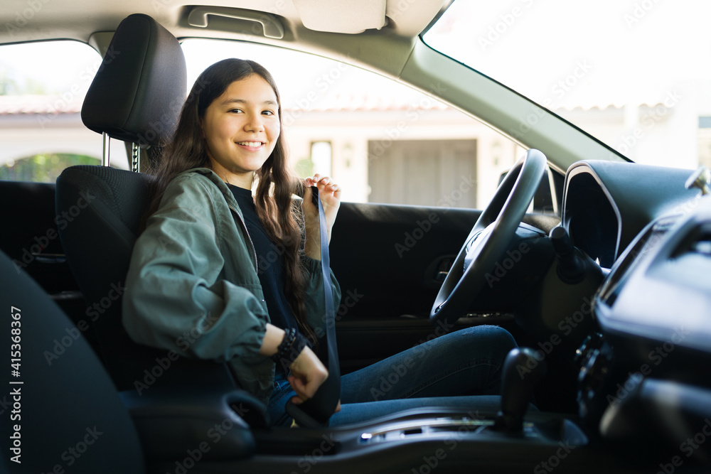 Teenager girl preparing to start her car and drive