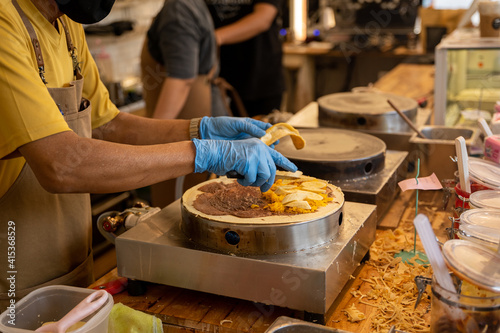 A man making Japanese Crepes dessert, Japanese crepes on the stove.